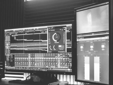 Screens showing a digital audio workstation and level meters