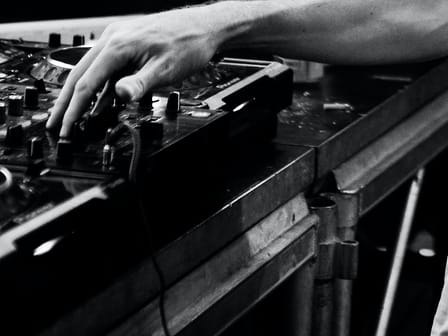 A hand on a mixing desk, close up